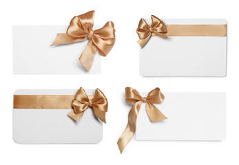 Blank cards with golden bows isolated on white, top view
