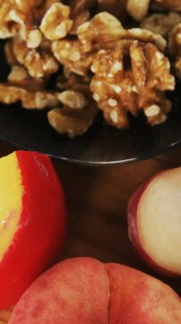 Bowl of green olives, spices, crispy biscuits, jam, rosemary herb, cheese and walnuts