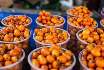 Seriguelas for sale at a market. Fruit source of fiber rich in vitamin C, flavonoids and carotenoids.