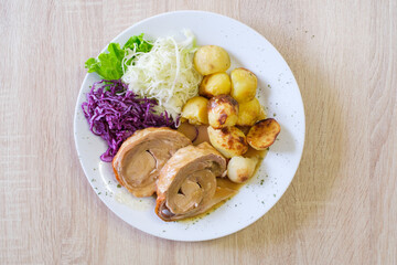Roasted meat with potatoes cabbage and red cabbage