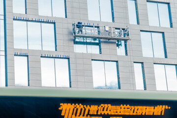 modern city building construction high platform process occupation and working with people back to camera near skyscraper and town neon foreground on a train