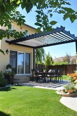 A patio with a black awning and a table with chairs and a dining table