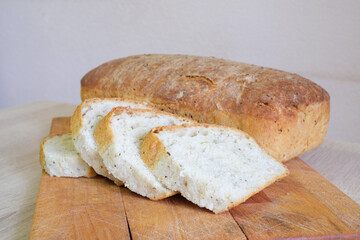 Sliced loaf of artisan bread on a wooden cutting board