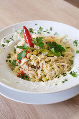 Creamy chicken risotto with vegetables and herbs