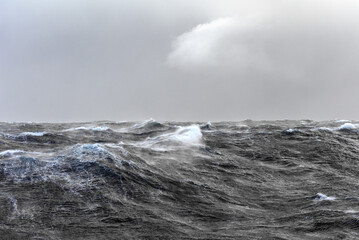 Rough seas. Ripples and spray.