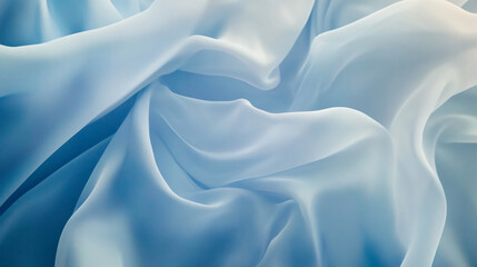 Fototapeta premium Delicate light blue fabric drapes softly creating elegant folds and textures