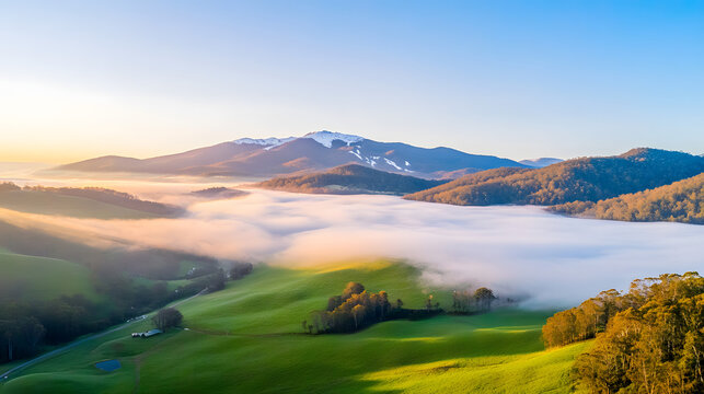Snowy Mountain Sunrisewith mist rolling through the valleys.