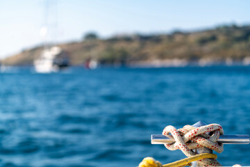sailors knot in front of the yacht boat. luxury and private concept. boat on the sea, summer cruise vacation. Sailing yacht fishing holidays. islands lifestyle. anchor rope tied. Tourism see view.