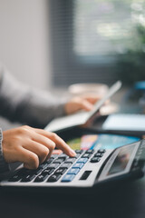 Finance bank tax expense accounting budget money businessman hand use calculator Financial...