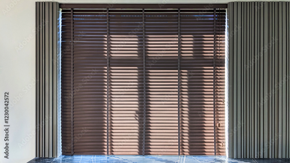 Poster modern interior with sunlight streaming through wood blinds, creating striking shadows on the floor 
