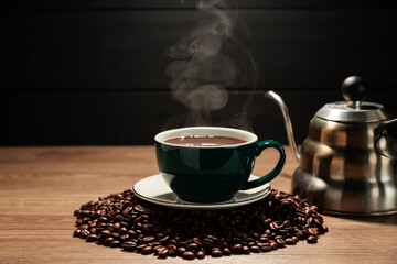 Coffee cups with roasted coffee beans arranged on a table with a black and dark background.