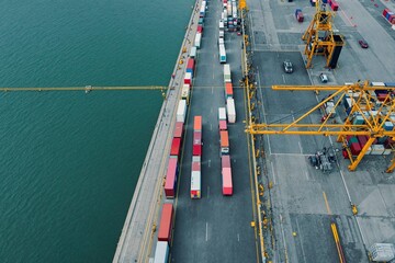 Cargo trucks loading containers at a busy commercial port