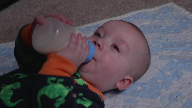 Baby Drinking Milk from a Bottle Wide