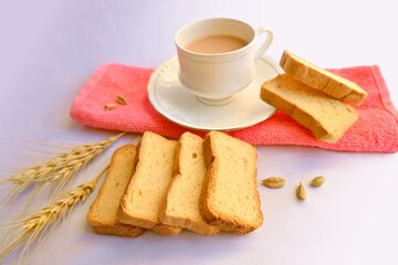 Rusk, wheat rusk with tea cup, with wheat ears and cardamom, white background