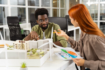 Two young architects working together on a new sustainable project