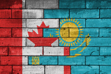 colourful painted big flag of canada and flag of kazakhstan on a massive old brick wall background. concept
