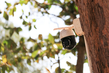 An old yet reliable CCTV camera mounted outdoors, exposed to sun and rain over the years, standing guard to ensure security for homes. A symbol of safety and modern surveillance technology.
