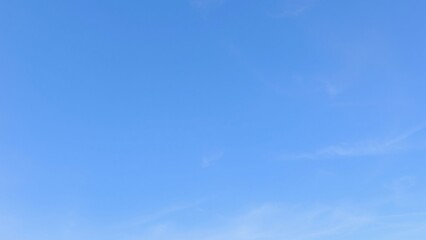 Serene Blue Sky with Subtle Cloud Formations