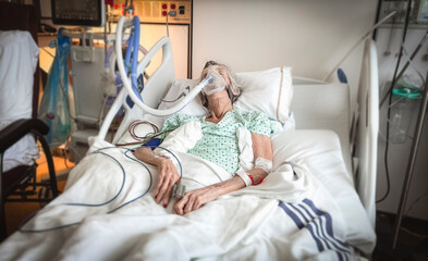 Portrait of senior woman sick lying in hospital bed, getting treatment