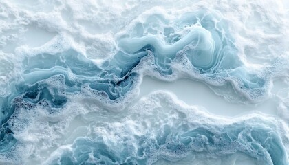 Naklejka premium Abstract blue and white foamy texture resembling water or ice formations.