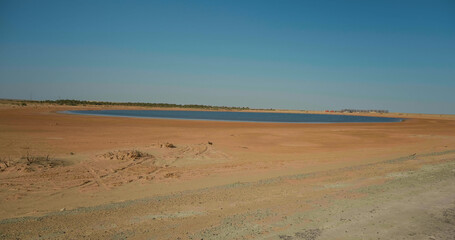 Large shot golden sand close up Sahara desert landscape with lake.