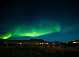 Beautiful northern lights over the fjord A view of the majestic Aurora Borealis dancing above the famous horizontally symmetrical waterfall at FÃ³Ã°urstaÃ°ir, Iceland. 