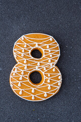 Decorative Gingerbread Number Eight. Black background