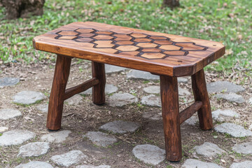rustic wooden picnic table featuring honeycomb inlays, perfect for outdoor gatherings. Its sturdy design complements any garden setting