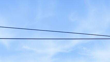 Two Parallel Wires Against a Clear Blue Sky