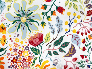 Close up of colorful random floral and leaves pattern printed fabric. Flower shape, green leaves, and foliage abstract pattern. Suitable for soft seating and upholstery. Seamless background texture.