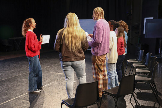Friends reading texts during rehearsal