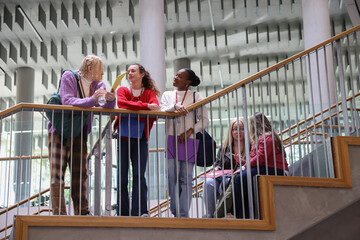 Disabled friends standing on stairs in community center