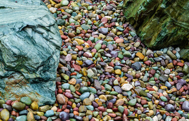 Multicolored rounded stones in the interior of a flowerbed near a recreation area, USA