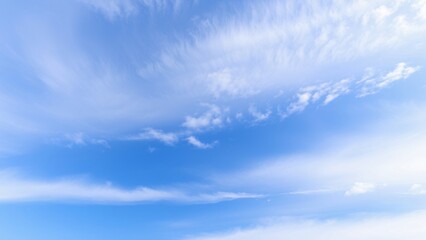 Obraz premium Serene Blue Sky with Wispy Clouds Peaceful Nature Background