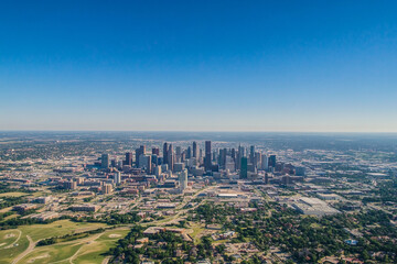 Urban skyline reflecting in calm water during late afternoon with clouds in the sky