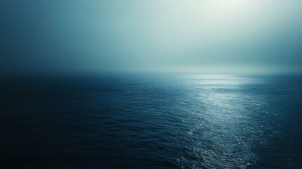 Obraz premium A vast expanse of the deep sea with a gradient of dark blue hues, illuminated by distant sunlight filtering from above