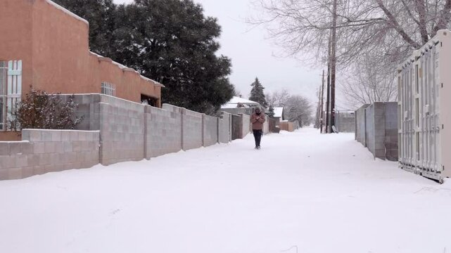 Man Slips and Almost Falls while Walking in the City Snow
