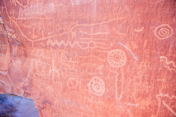 The wall is covered in drawings and symbols