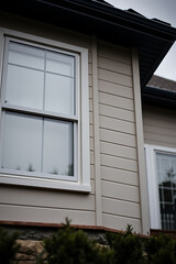 Fototapeta premium Modern Home Exterior: Architectural Design and Window Details. High-quality image showcasing the beauty of contemporary residential architecture, focusing on window design and exterior finishes.