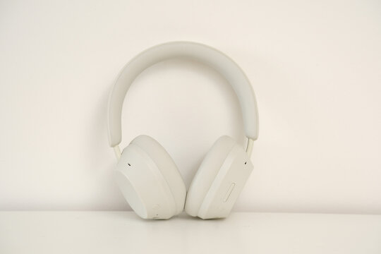 Stylish White Wireless Headphones Positioned on a Beautifully Minimalist Background Scene