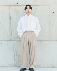 Minimalist Fashion Young Professional in Crisp White Shirt and Beige Trousers Against Concrete - Modern Style Guide for Urban Menswear Marketing