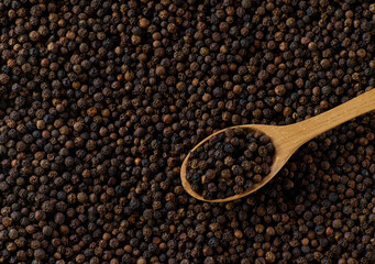 Dry black pepper seeds, top view. Flat design. Macro spice background.