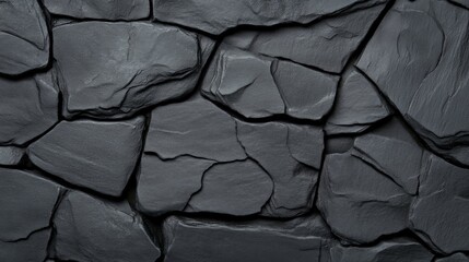 Dark Grey Stone Wall Texture: A dramatic close-up shot reveals the raw texture of a dark grey stone wall, showcasing the irregular shapes and crevices of the natural stone.