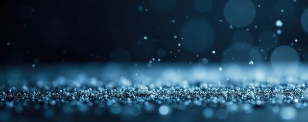 A flurry of tiny snowflakes falls on a black and icy surface, fluttering, snowy