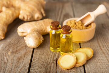 Ginger essential oil on texture background. Fresh ginger slices. Essence, serum, oil. Alternative medicine. Phytotherapy. Health and beauty concept. Place for text. Copy space.