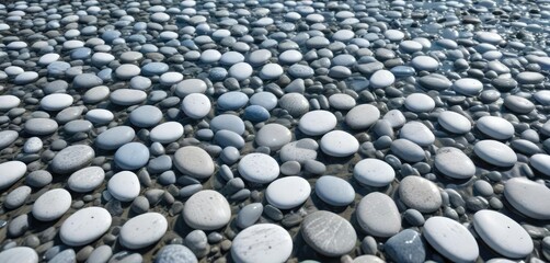 Light blue and white pebbles creating a beautiful pattern in shallow water, bright, wet