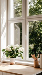 Fototapeta premium Sunlight streams through a large window in a bright kitchen, illuminating a clear vase filled with white and blue hydrangeas on a light wooden table, with a lush garden view outside