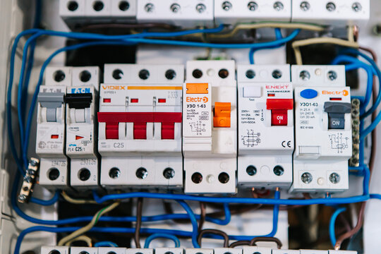 Khmelnytskyi, Ukraine - 9 December, 2022: Close-up of an electrical panel displaying multiple circuit breakers, some switched on and some off, connections illustrating complexity of electrical systems