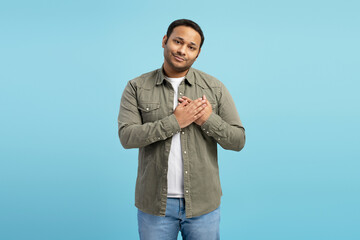 Grateful man holding hands on chest showing appreciation and gratitude