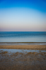 Tranquil beach with calm sea and clear sky